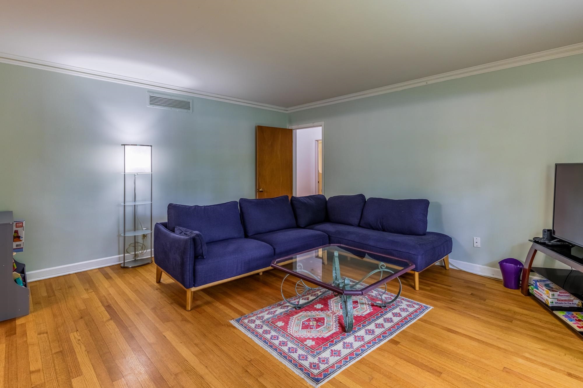4313 Rhodes Avenue Memphis, TN 38111 - Photo 7 of 25 a living room with a couch and a flat screen tv