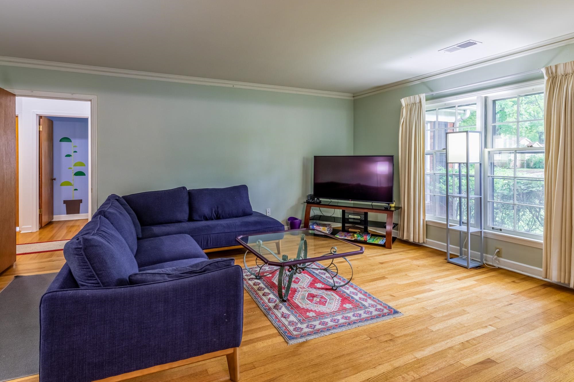 4313 Rhodes Avenue Memphis, TN 38111 - Photo 8 of 25 a living room with furniture and a flat screen tv