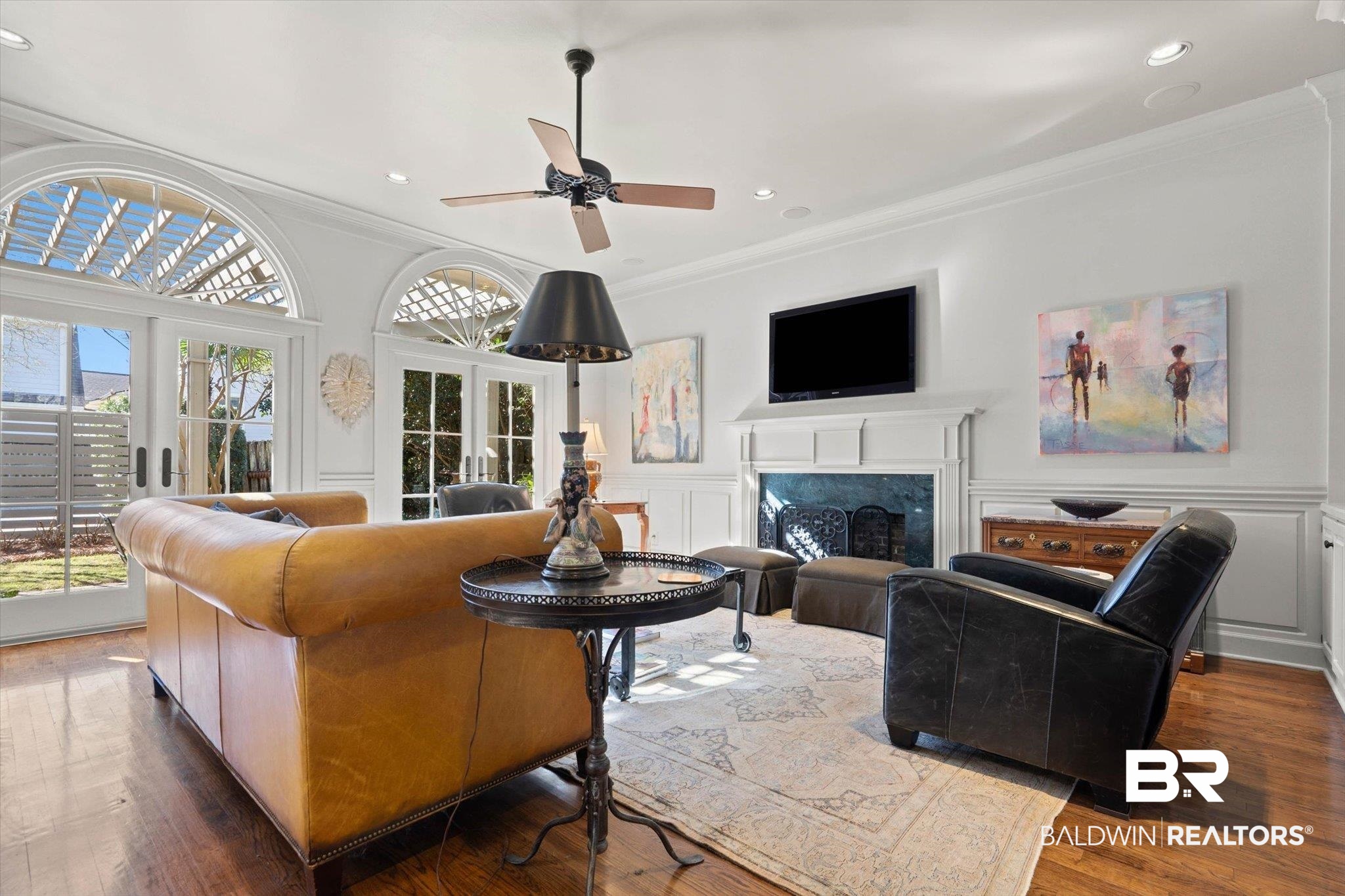 3615 Stein Street Mobile, AL 36608 - Photo 17 of 44 Living room with a decorative wall, crown molding, a fireplace, hardwood / wood-style flooring, and wainscoting