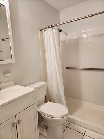 a white toilet sitting next to a bath tub