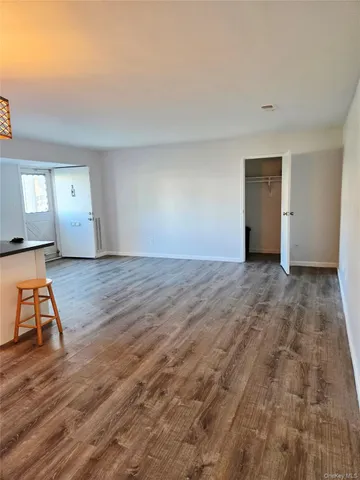 a view of an empty room and wooden floor