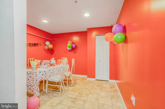 a view of a room with a table and chairs