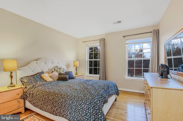 a bedroom with bed and a large window