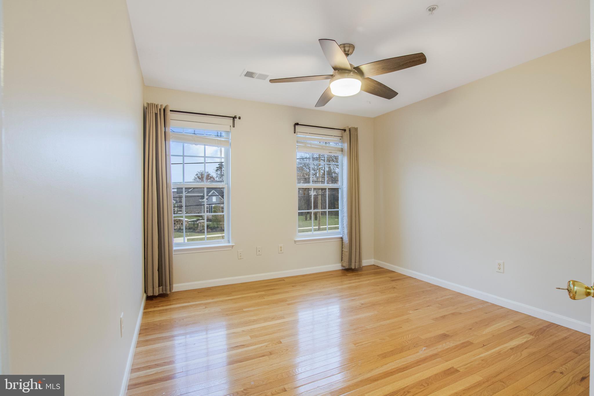 11809 Old Fort Road Fort Washington, MD 20744 - Photo 26 of 40 a view of an empty room with wooden floor and a window