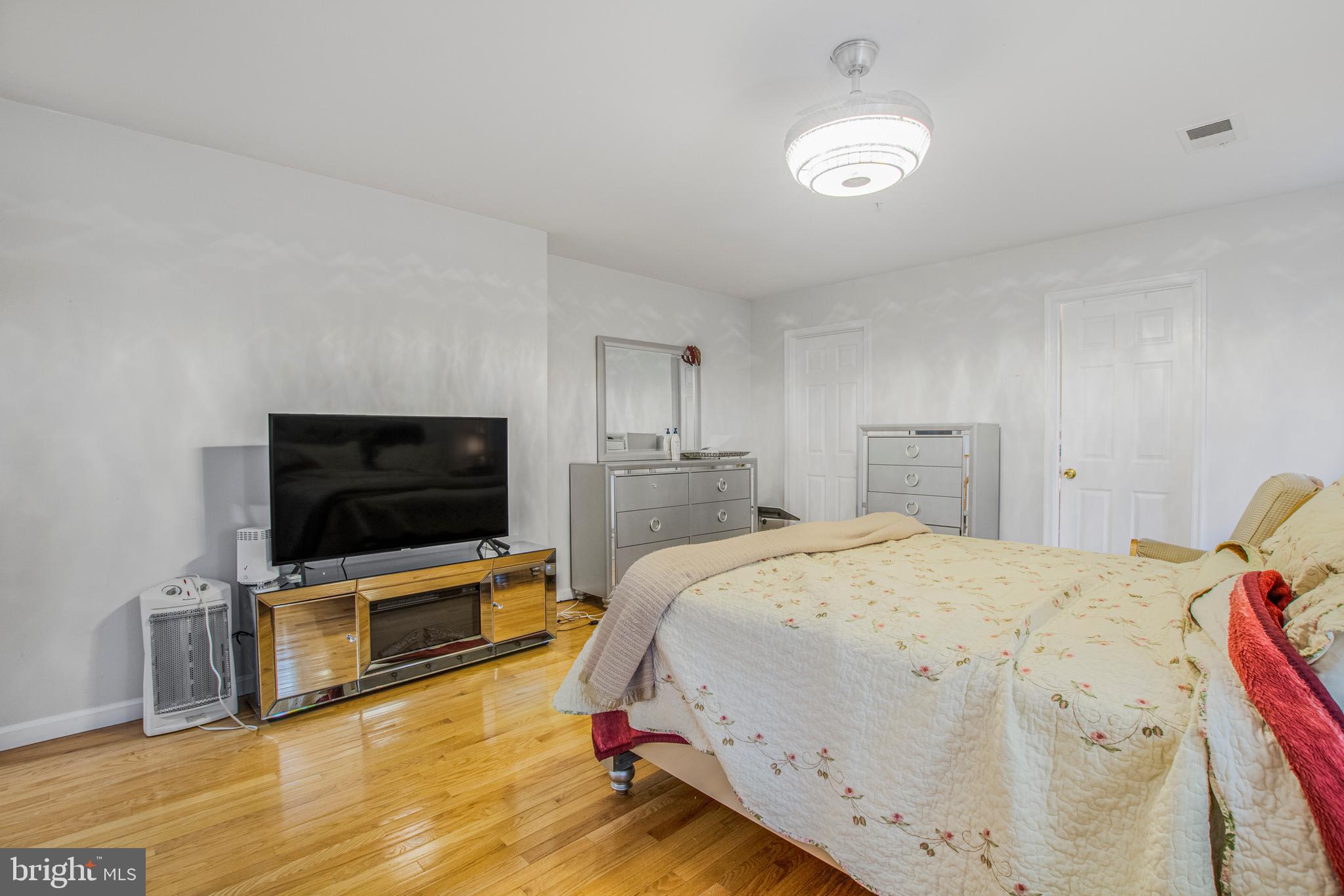 11809 Old Fort Road Fort Washington, MD 20744 - Photo 28 of 40 a spacious bedroom with a bed and a flat screen tv