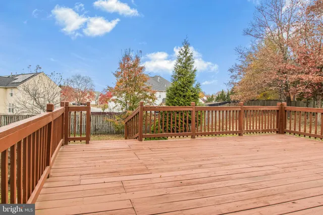 a balcony with wooden floor and fence