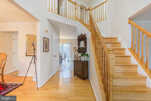 a view of entryway and hall with wooden floor