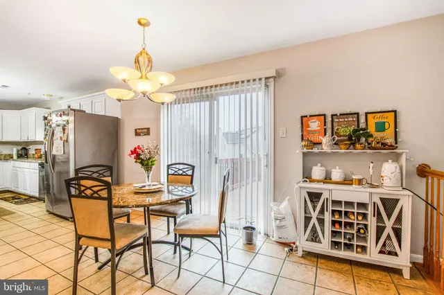 a view of a dining room with furniture and chandelier