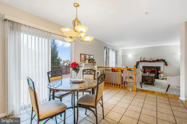 a view of a dining room with furniture and a chandelier