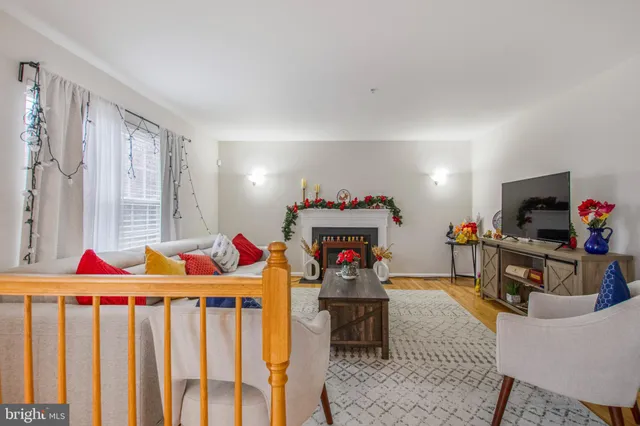 a living room with furniture a flat screen tv and a window