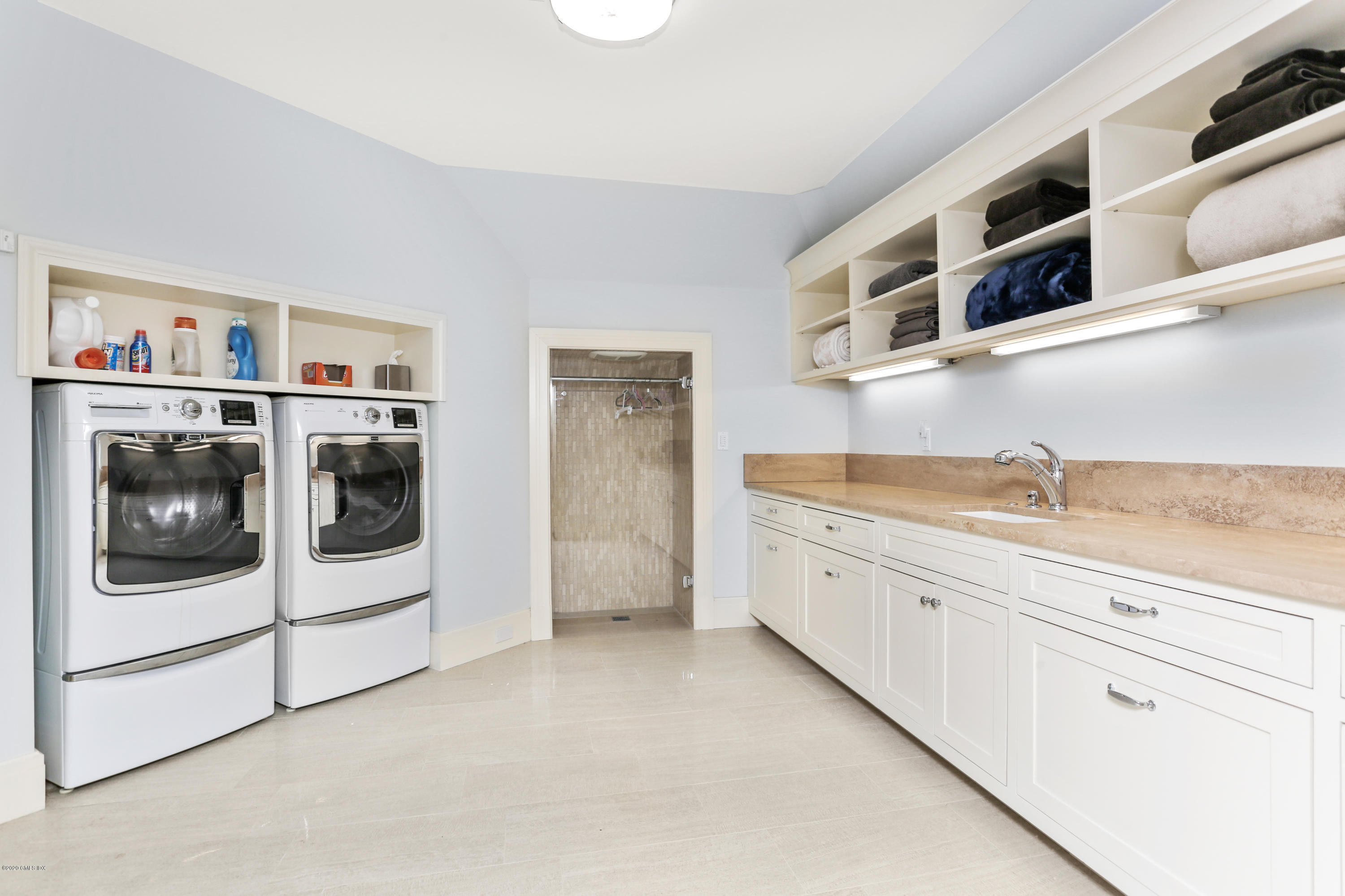 125 Cat Rock Road Cos Cob, CT 06807 - Photo 32 of 33 a kitchen with stainless steel appliances granite countertop a washer and dryer