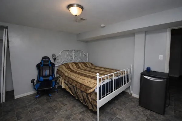 a bedroom with a bed and dresser