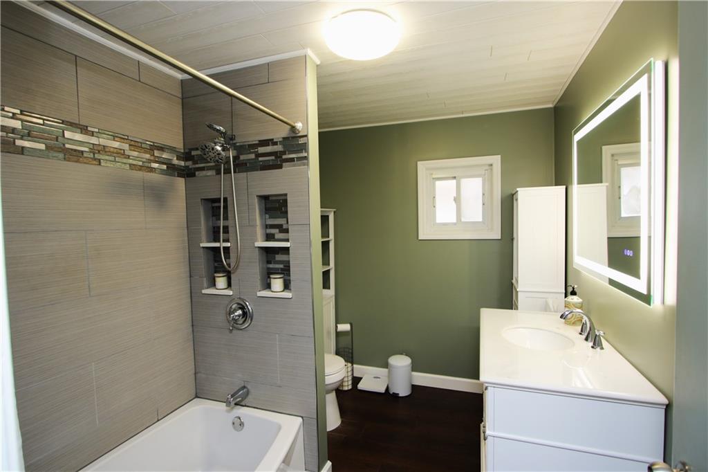1930 State Rte 2023 Monongahela, PA 15063 - Photo 10 of 41 Attractively Remodeled Full Bathroom on 1st floor w/ Ceramic Subway Tile Tub Surround w/ Glass Mosaic Trim offering built-in shelving, Newer Flooring, Tub, Toilet, Vanity & LED edge-lit Vanity Mirrow allowing 3 light settings