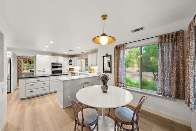 a kitchen with counter space dining table and chairs