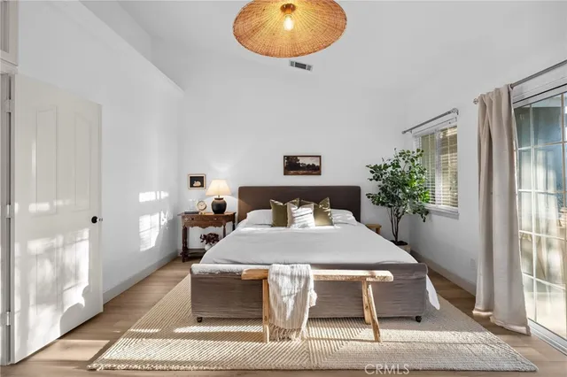 a bedroom with a bed and a chandelier