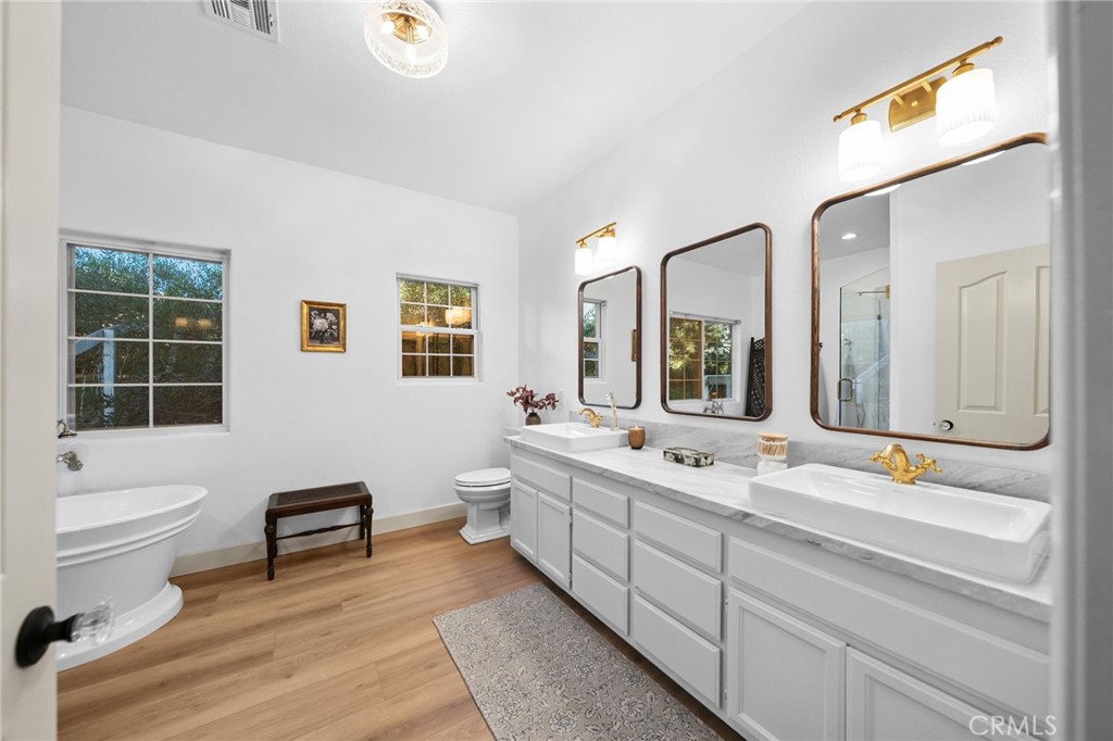 42333 Casa Verde Temecula, CA 92592 - Photo 18 of 44 a bathroom with a double vanity sink a toilet and a tub