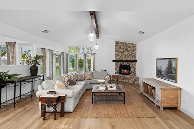 a living room with furniture a fireplace and a table