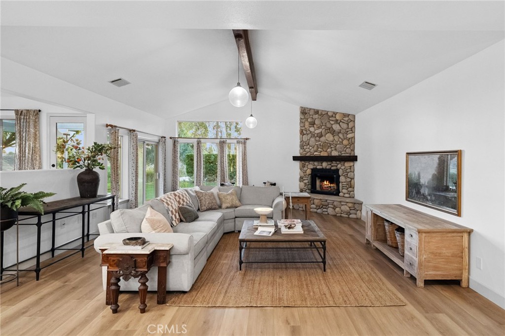 42333 Casa Verde Temecula, CA 92592 - Photo 8 of 44 a living room with furniture a fireplace and a table