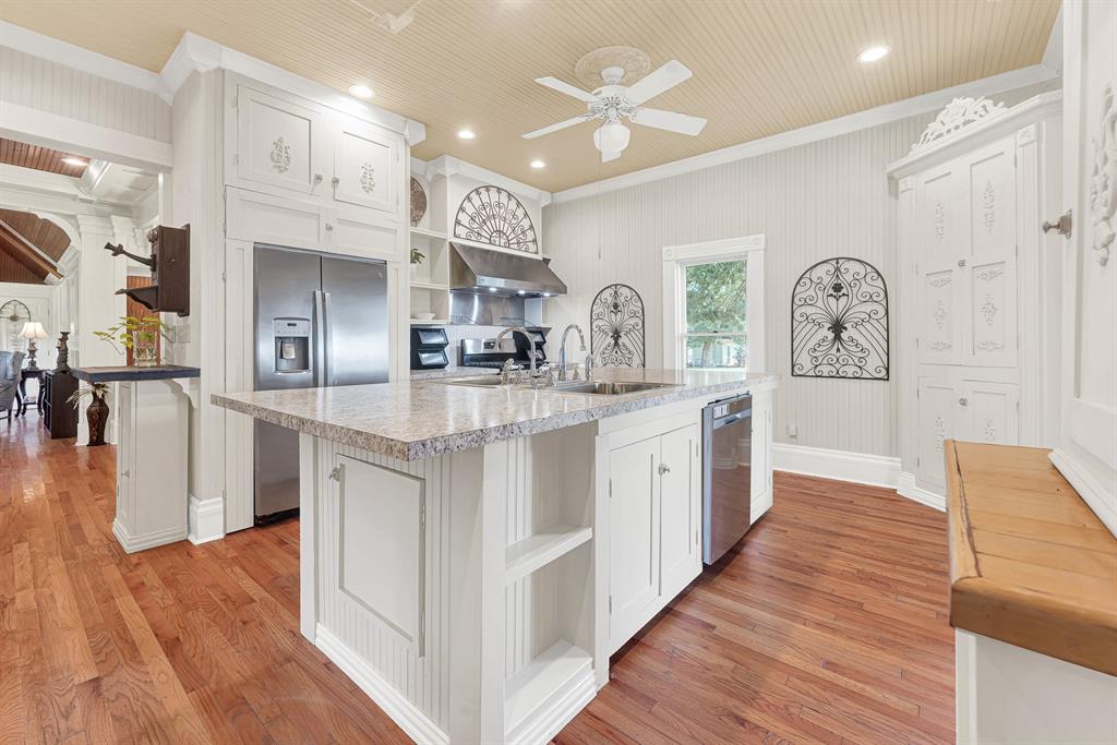 1425 Lone Star Road Celina, TX 75009 - Photo 3 of 40 The oversized island anchors the kitchen beneath soaring beadboard ceilings, creating an open workspace filled with natural light and timeless character. Picture everyone gathering here over pancakes and coffee before heading out to enjoy the property's wide-open spaces.