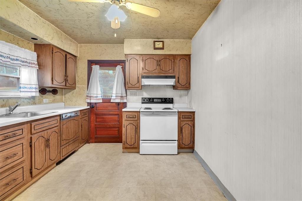 643 Agnew Road Pittsburgh, PA 15227 - Photo 11 of 49 a kitchen with stainless steel appliances a white stove top oven and sink