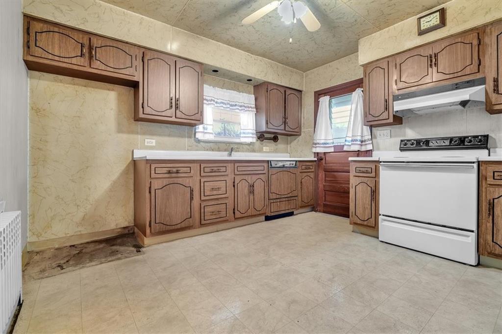 643 Agnew Road Pittsburgh, PA 15227 - Photo 14 of 49 a kitchen with stainless steel appliances granite countertop a stove and a sink