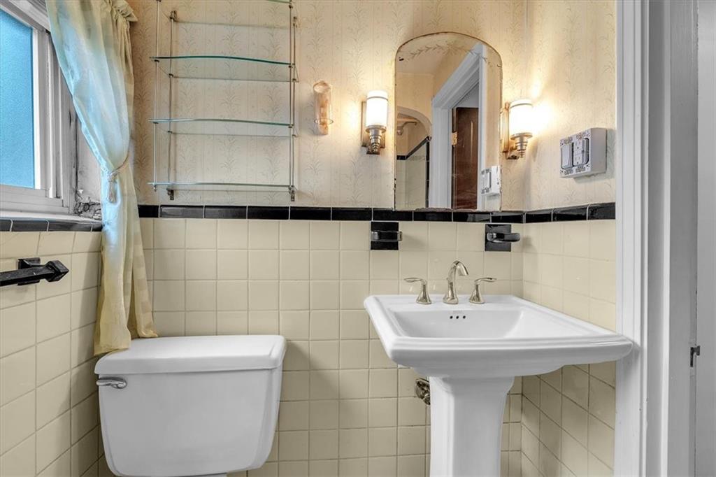 643 Agnew Road Pittsburgh, PA 15227 - Photo 30 of 49 a bathroom with a sink and mirror with toilet