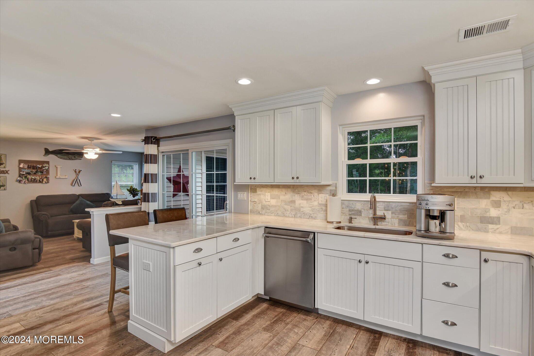 29 Nate Lane Howell, NJ 07731 - Photo 11 of 42 a kitchen with a sink window and cabinets