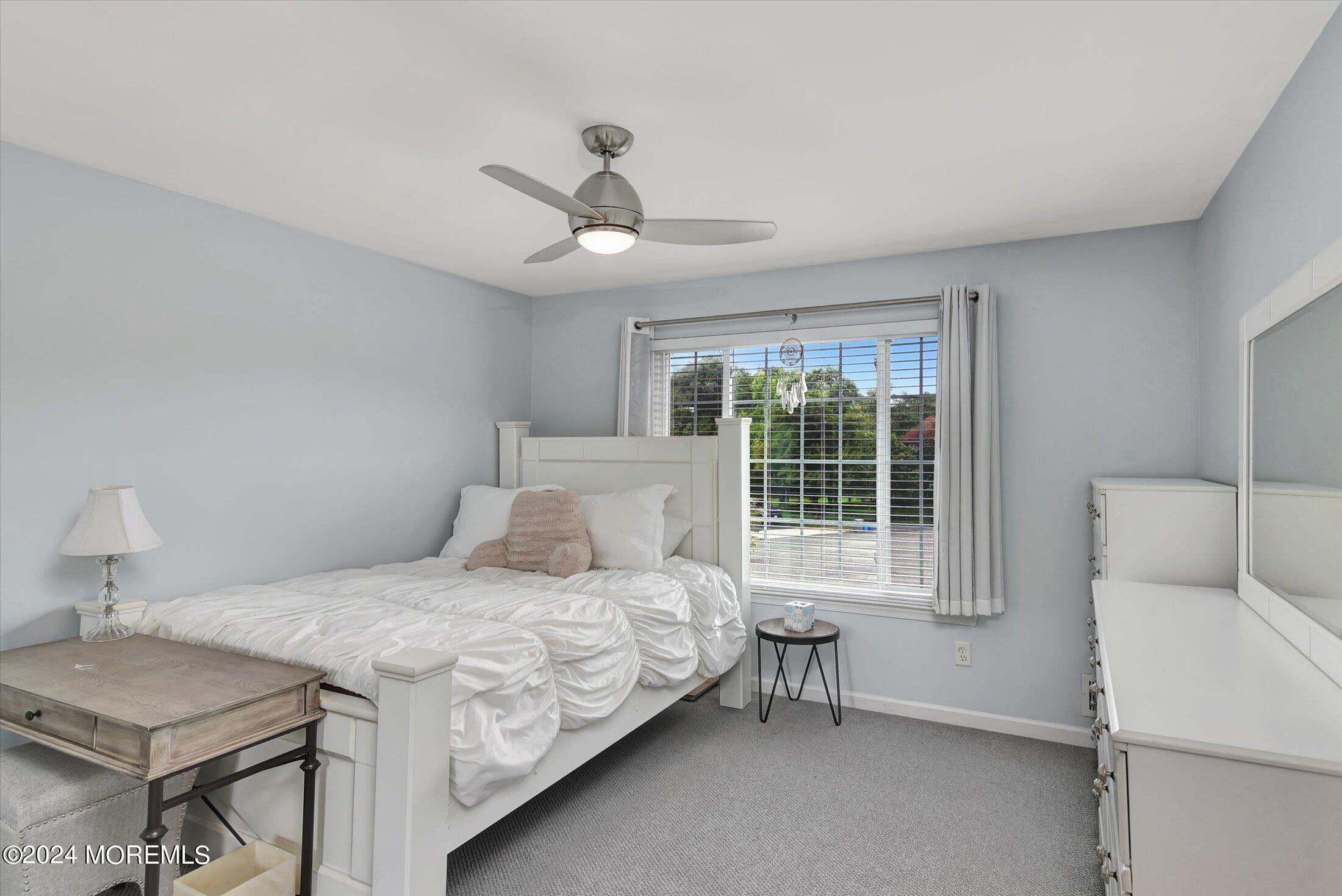 29 Nate Lane Howell, NJ 07731 - Photo 17 of 42 a bedroom with a bed and a table in it