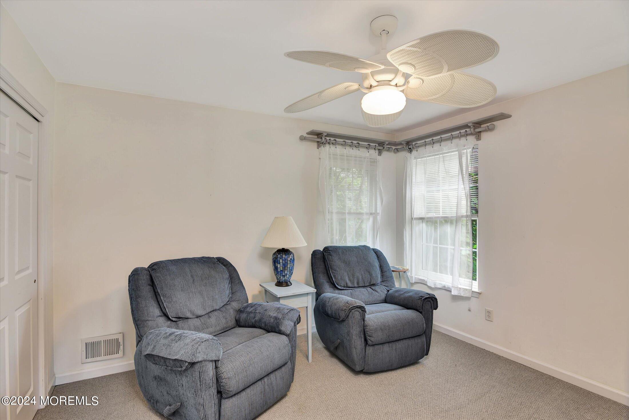 29 Nate Lane Howell, NJ 07731 - Photo 18 of 42 a living room with furniture and a large mirror