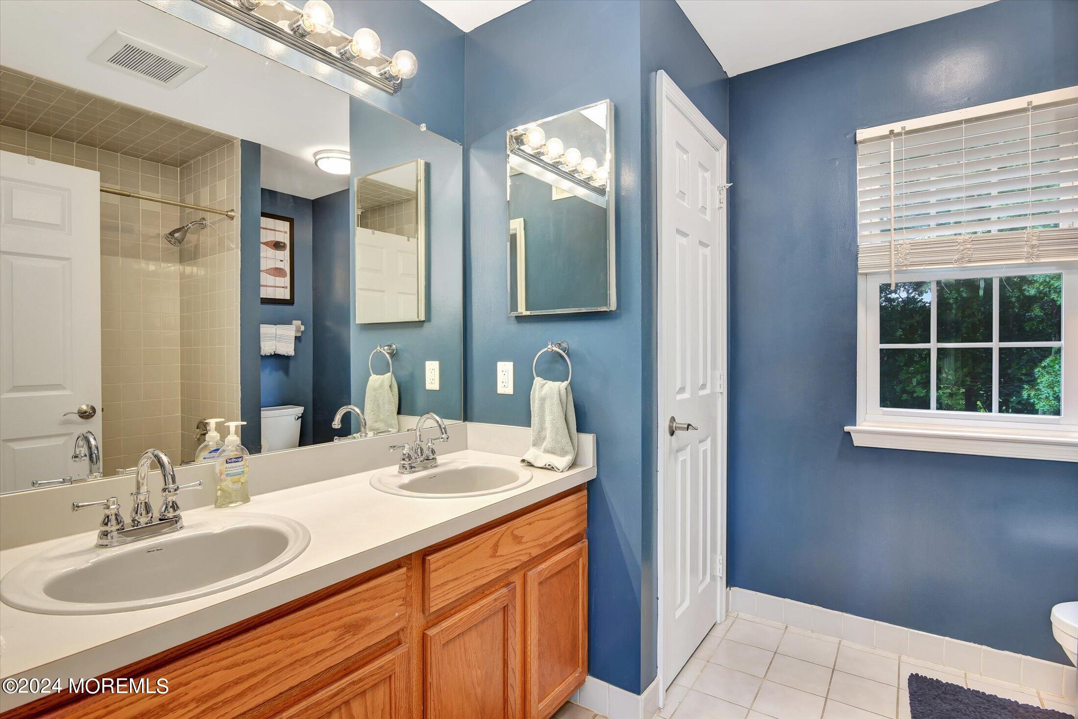29 Nate Lane Howell, NJ 07731 - Photo 20 of 42 a bathroom with a granite countertop sink and a mirror