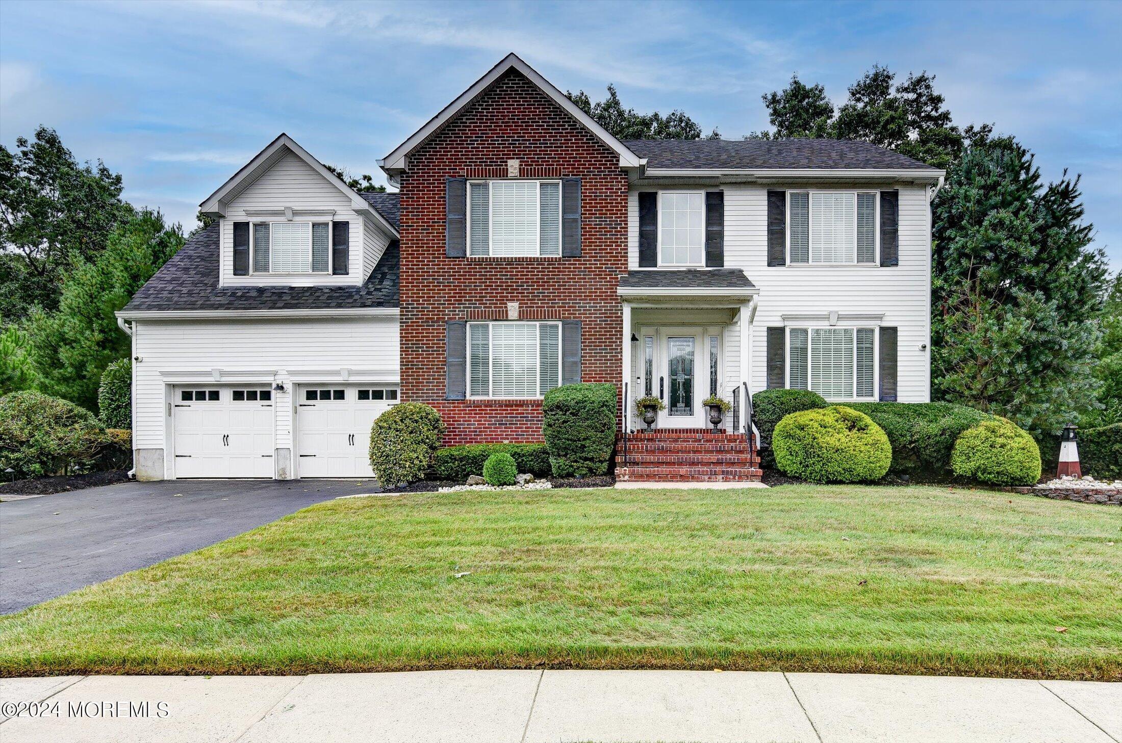 29 Nate Lane Howell, NJ 07731 - Photo 2 of 42 a front view of a house with a yard