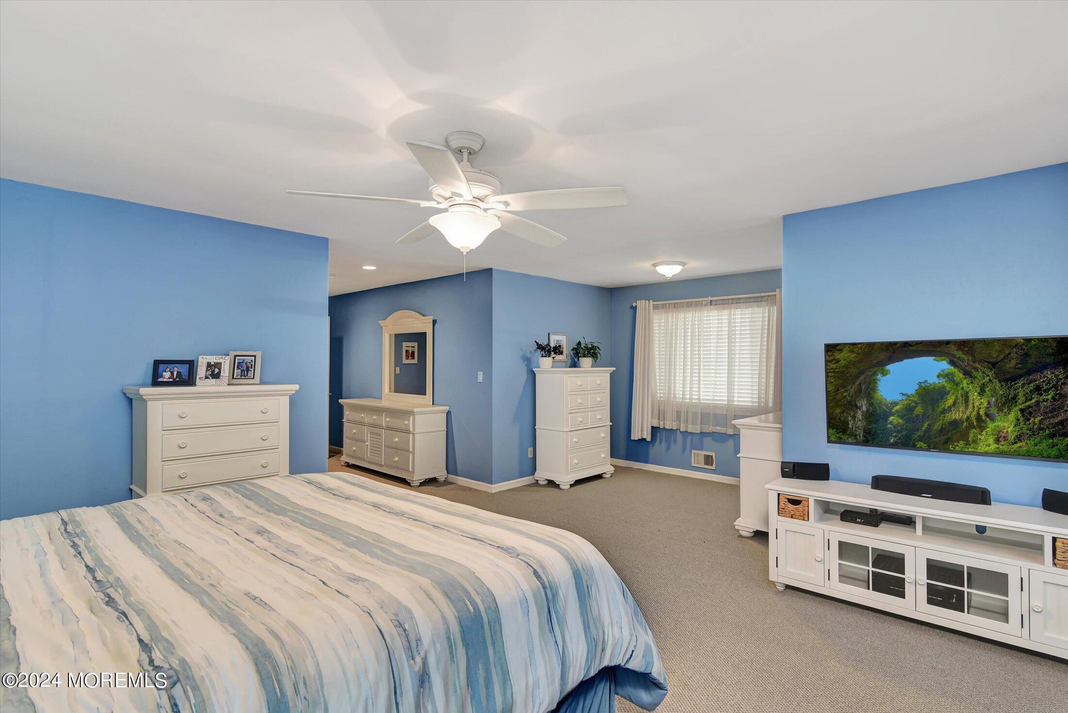29 Nate Lane Howell, NJ 07731 - Photo 23 of 42 a bedroom with a bed and a flat screen tv