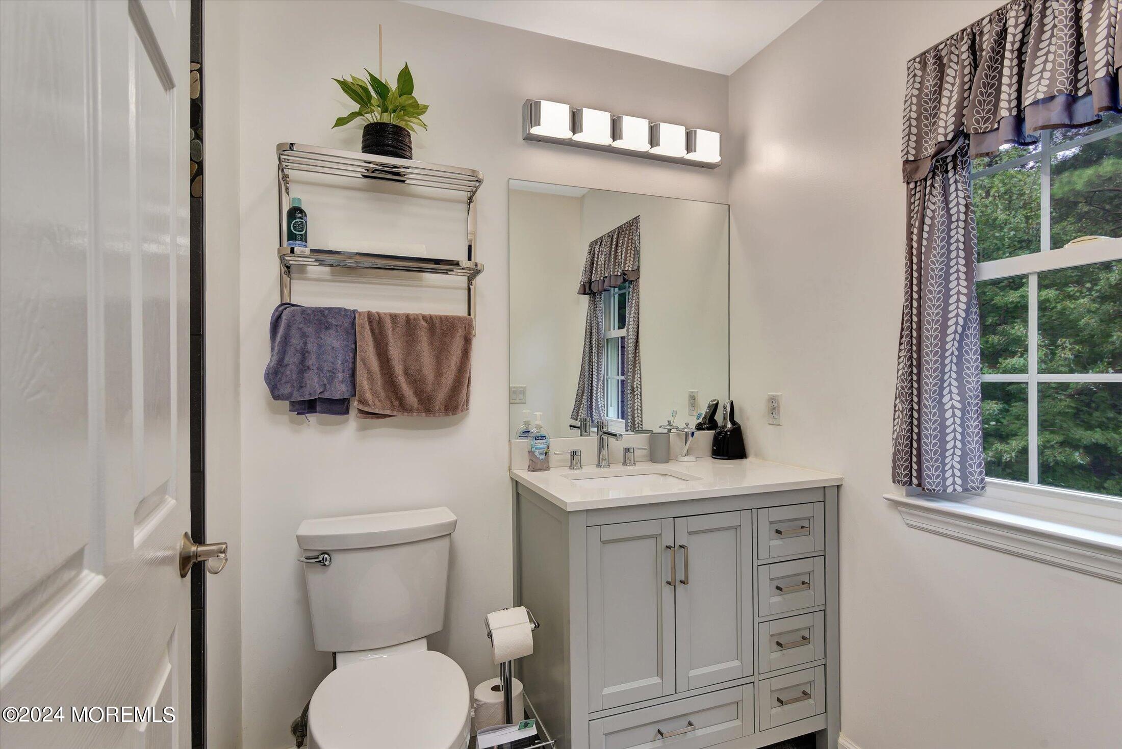 29 Nate Lane Howell, NJ 07731 - Photo 24 of 42 a bathroom with a toilet sink and mirror