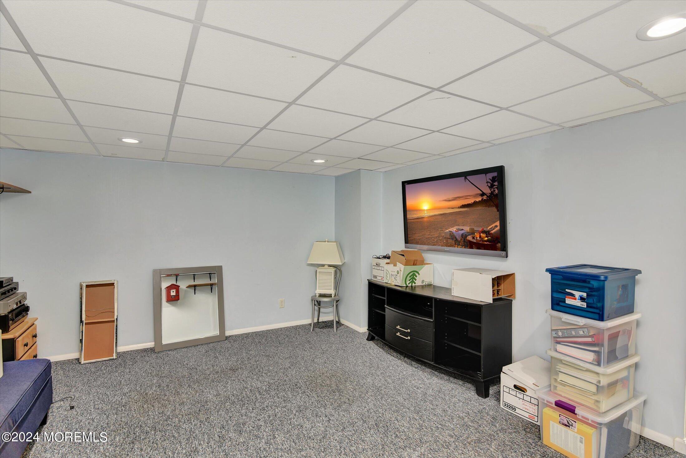 29 Nate Lane Howell, NJ 07731 - Photo 26 of 42 a living room with furniture and a flat screen tv