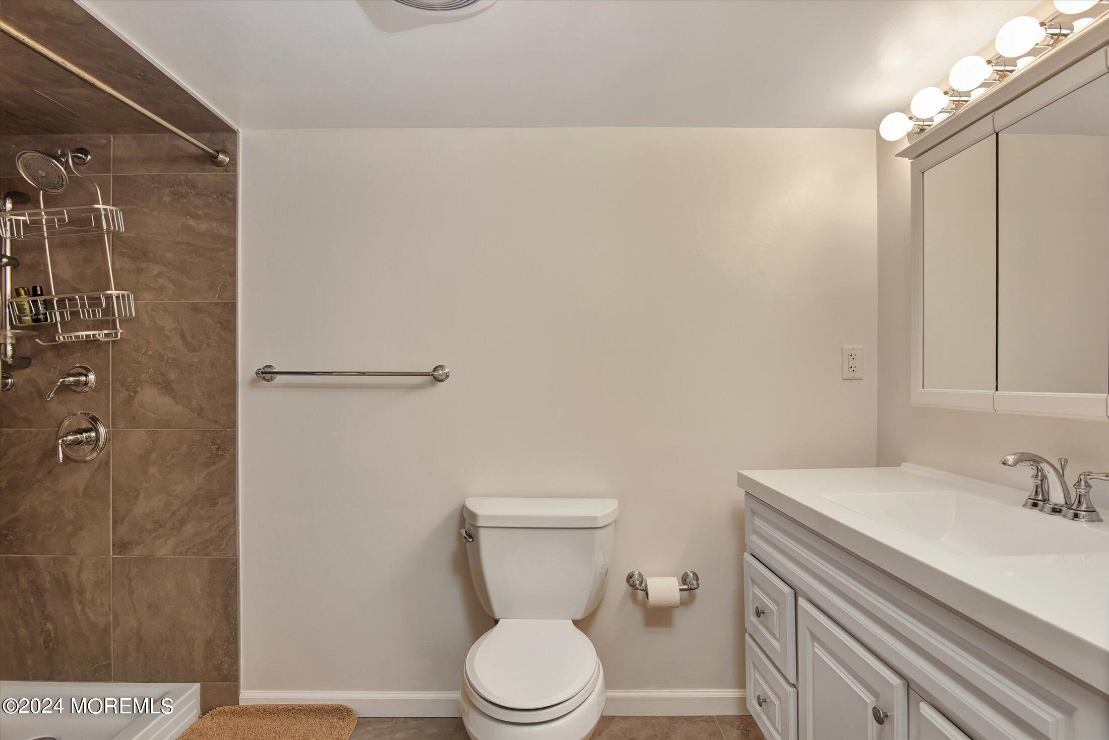 29 Nate Lane Howell, NJ 07731 - Photo 29 of 42 a white toilet sitting next to a bathroom sink
