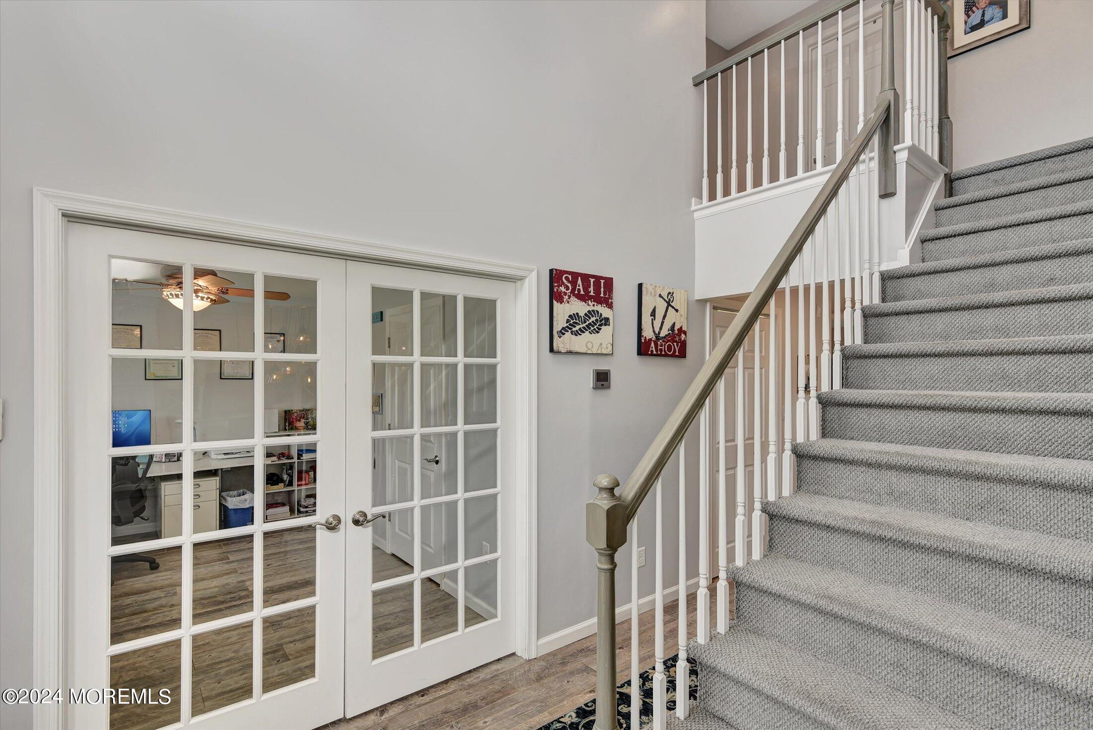29 Nate Lane Howell, NJ 07731 - Photo 5 of 42 a view of staircase with wooden floor and a window
