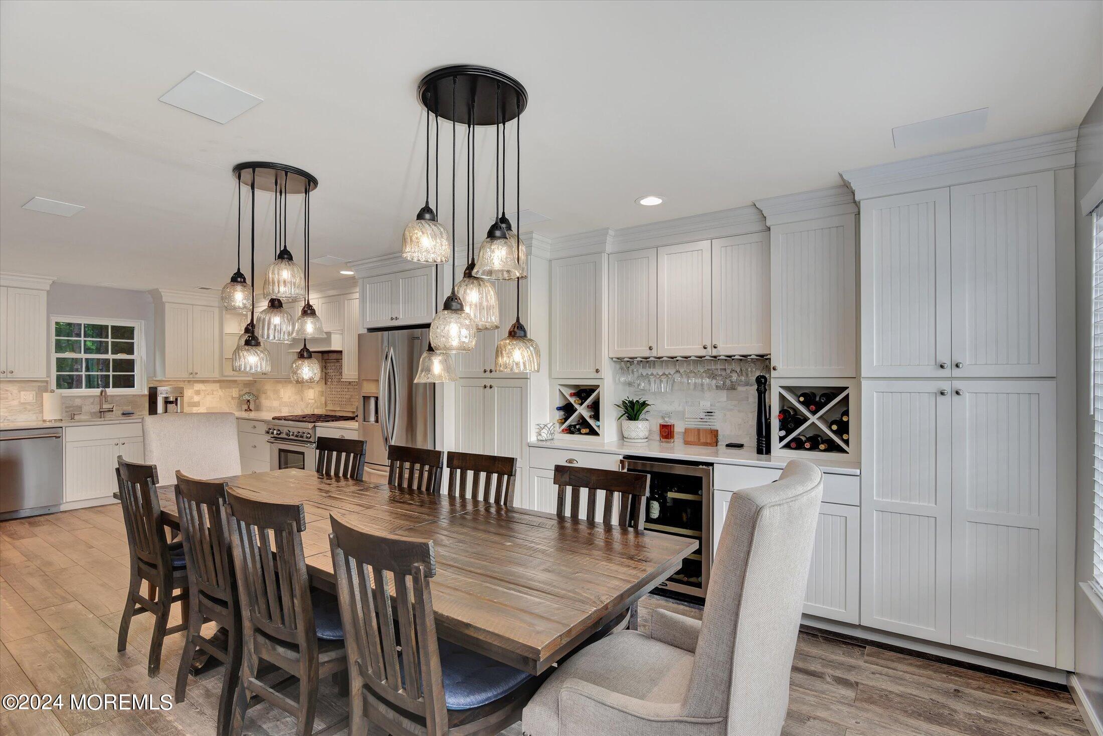 29 Nate Lane Howell, NJ 07731 - Photo 8 of 42 a kitchen with kitchen island a dining table chairs stainless steel appliances and cabinets
