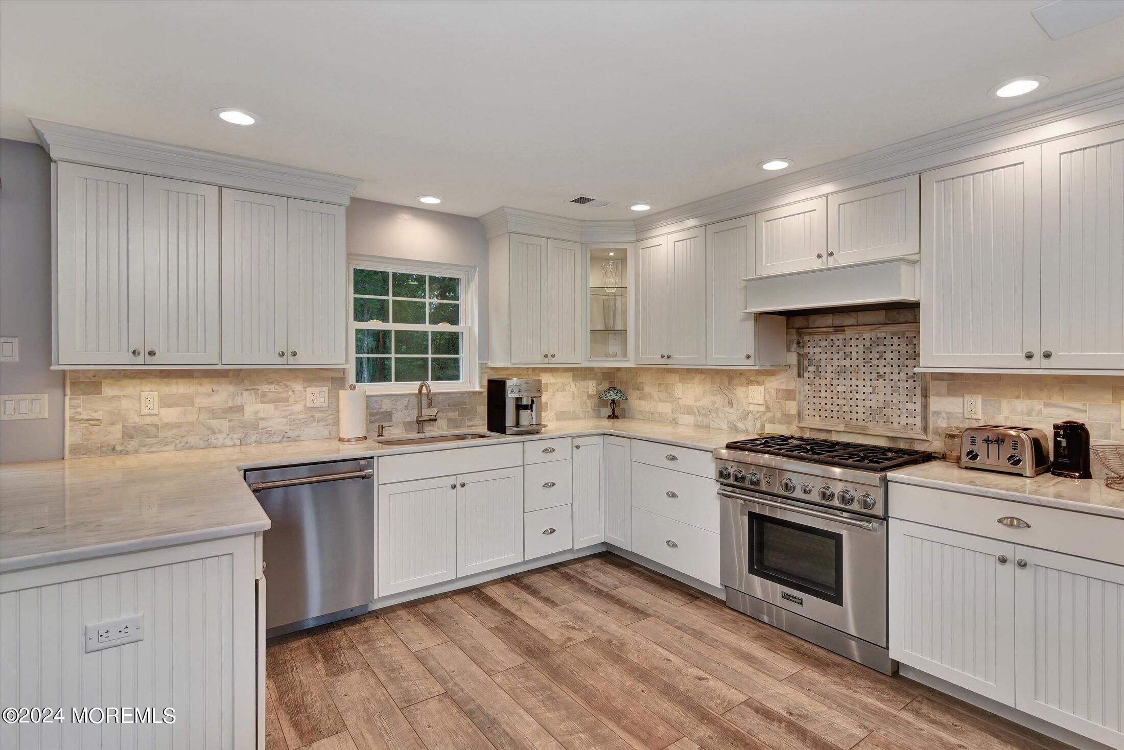 29 Nate Lane Howell, NJ 07731 - Photo 10 of 42 a kitchen with a stove top oven sink and cabinets