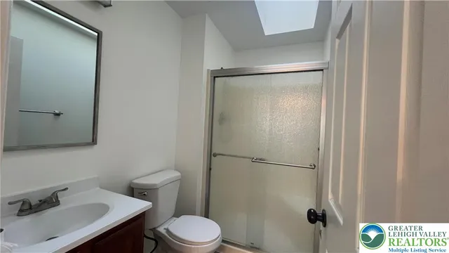 a bathroom with a granite countertop sink a mirror and a shower