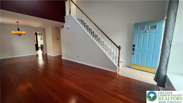 a view of an entryway with wooden floor