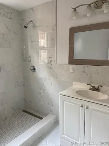a bathroom with a sink a vanity and a mirror