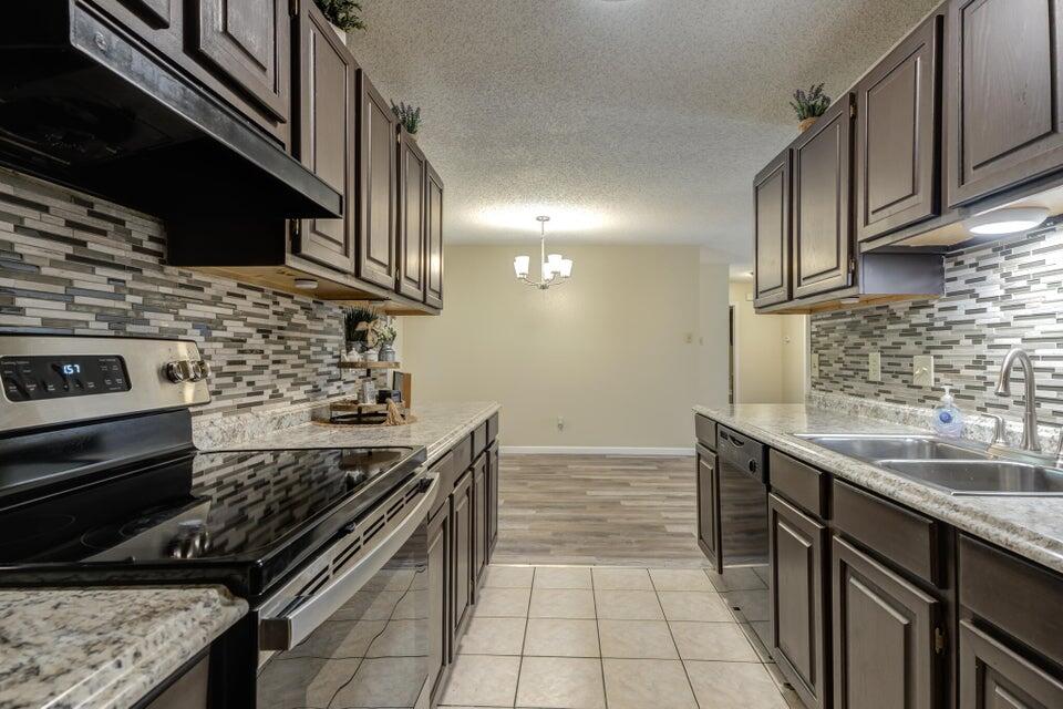 3401 101st Street Lubbock, TX 79423 - Photo 13 of 28 a kitchen with a stove and a sink