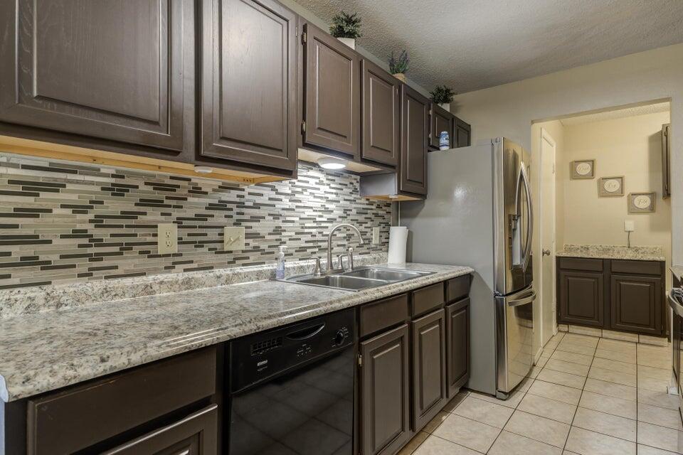 3401 101st Street Lubbock, TX 79423 - Photo 14 of 28 a kitchen with stainless steel appliances granite countertop a sink stove and refrigerator