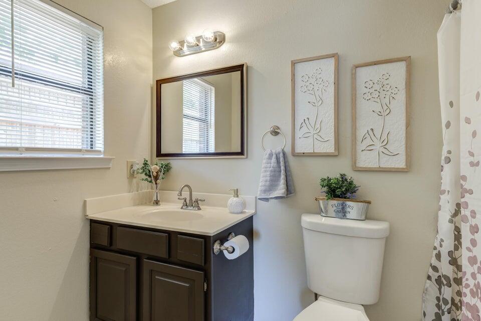 3401 101st Street Lubbock, TX 79423 - Photo 21 of 28 a bathroom with a toilet sink and mirror
