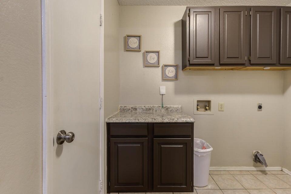 3401 101st Street Lubbock, TX 79423 - Photo 28 of 28 a bathroom with a granite countertop sink and a mirror