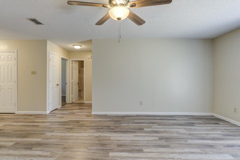 3401 101st Street Lubbock, TX 79423 - Photo 10 of 28 a view of a room with an empty ceiling fan