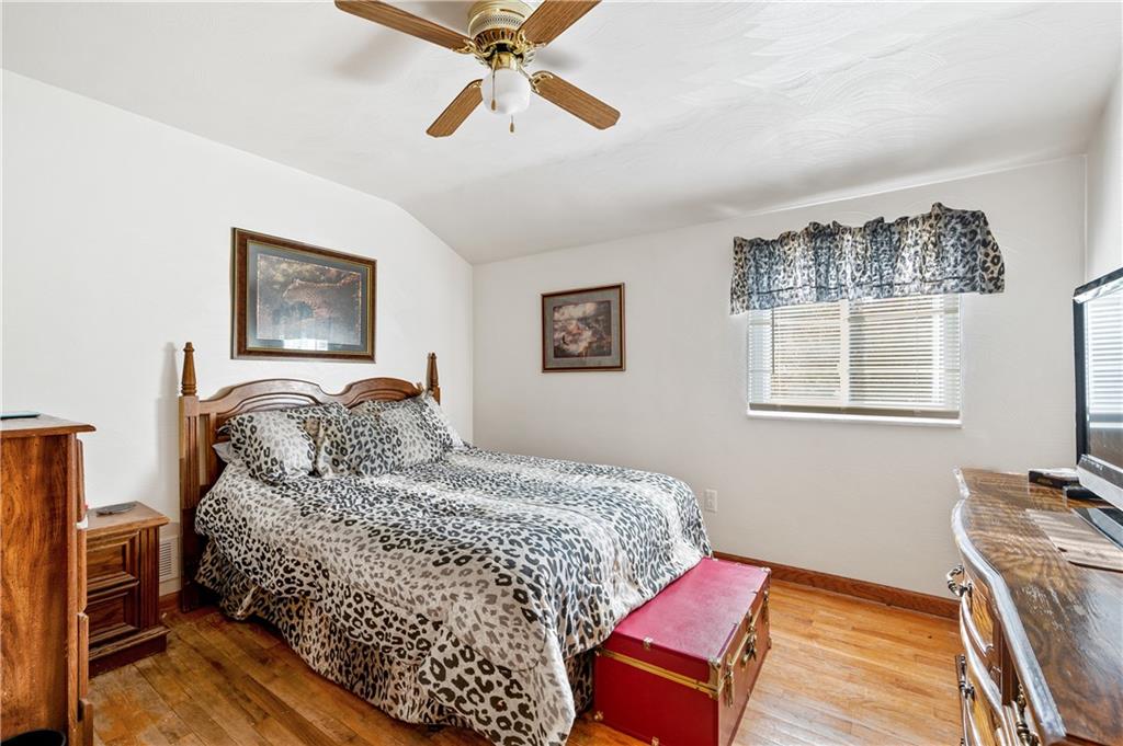 1027 Fiddleback Drive McKees Rocks, PA 15136 - Photo 17 of 25 a bedroom with a bed and wooden floor
