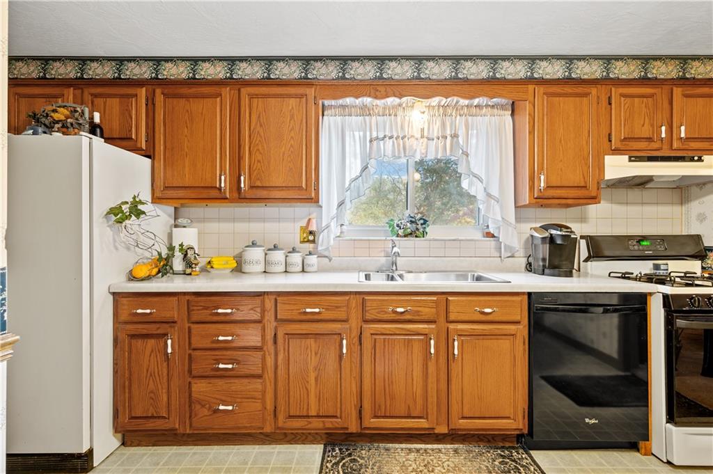 1027 Fiddleback Drive McKees Rocks, PA 15136 - Photo 2 of 25 a kitchen with stainless steel appliances granite countertop a sink and a refrigerator