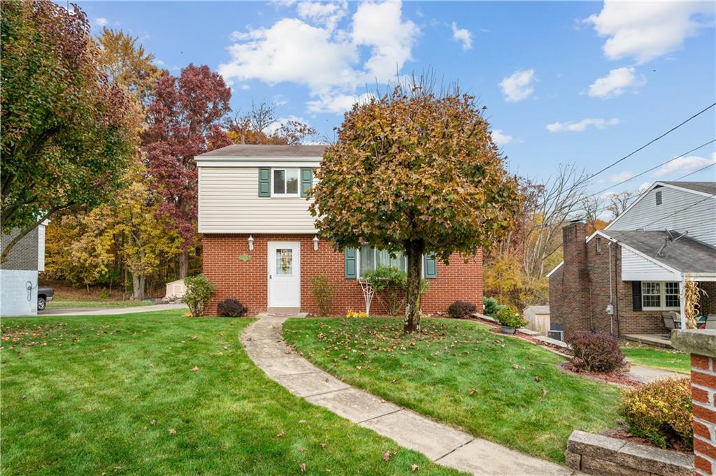 1027 Fiddleback Drive McKees Rocks, PA 15136 - Photo 24 of 25 a front view of a house with a garden and trees