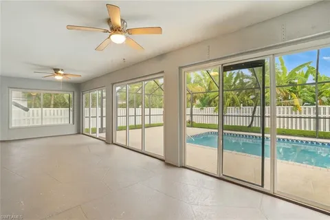 a view of an empty room with a fireplace and a large window with outer view